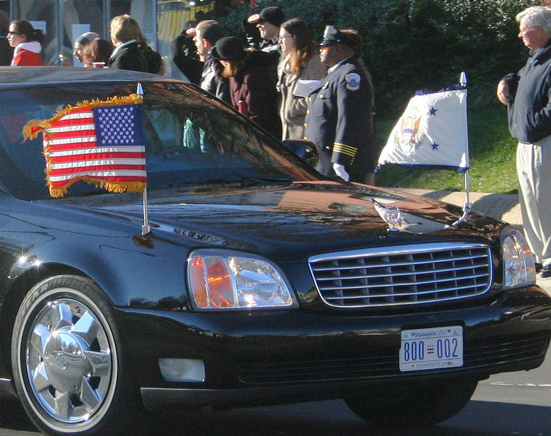 an american flag is tied to the back of a limousine