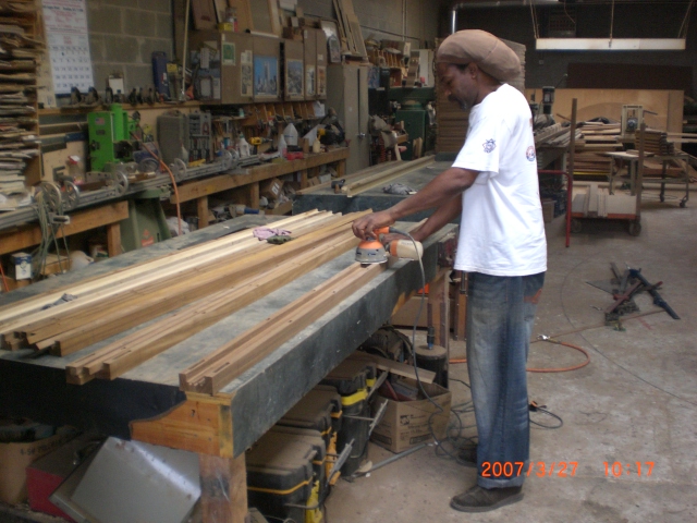 the man is working on a piece of wood