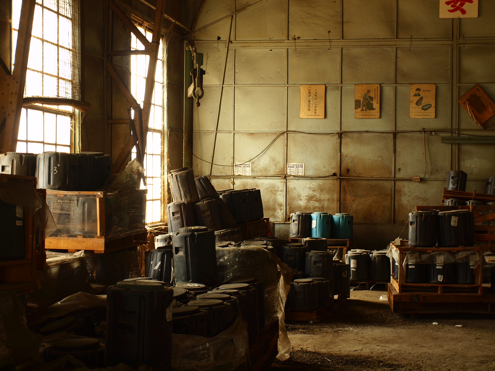 an abandoned room with many stacks of old barrels and boxes