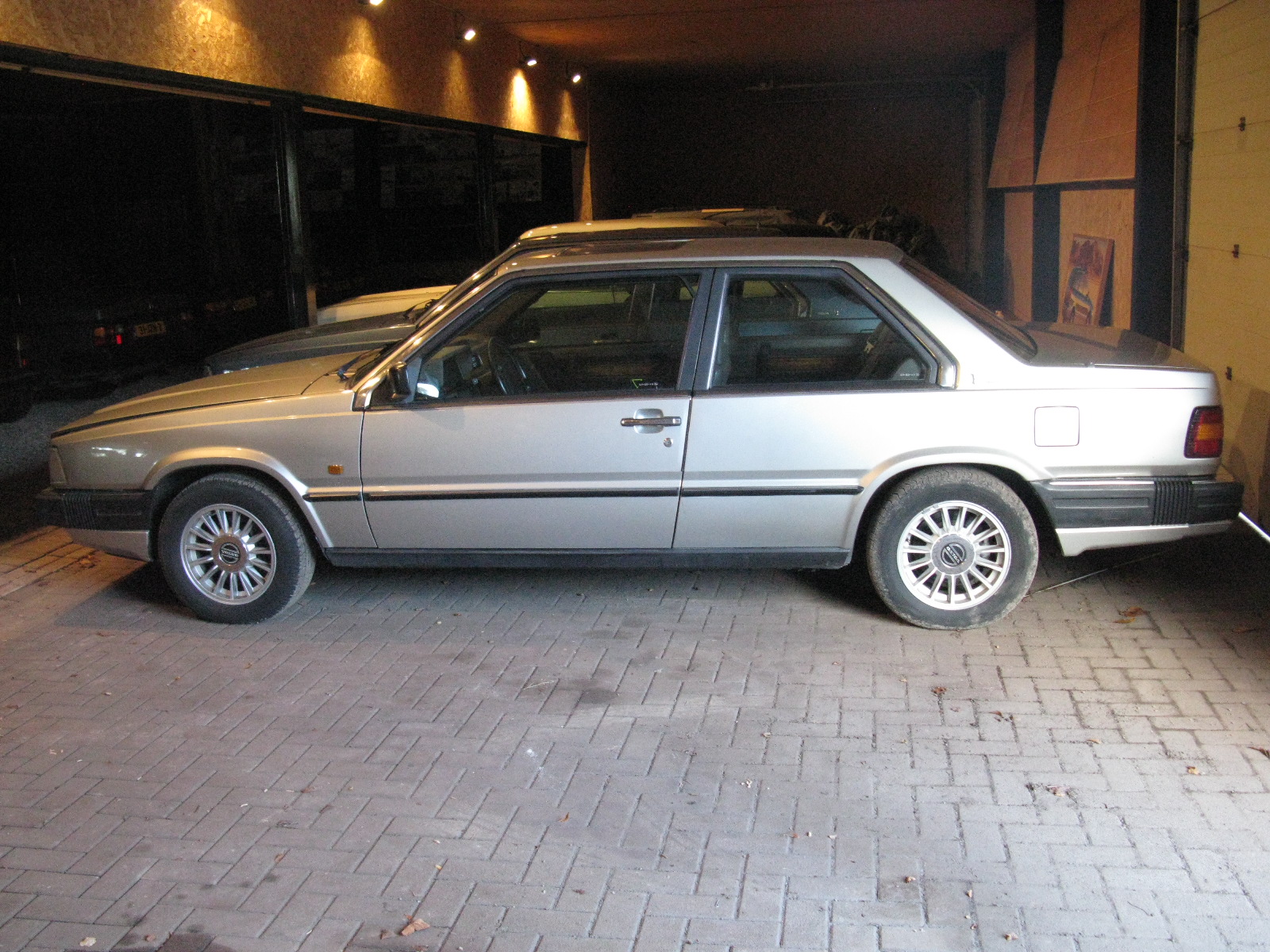 an older model car parked in a garage