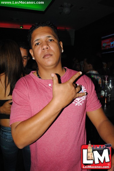 a man in a pink shirt pointing to soing