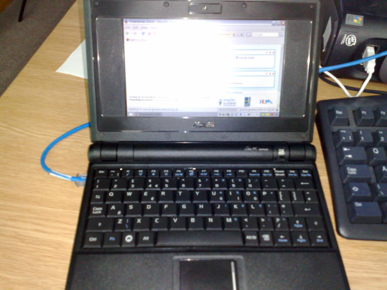 an open laptop computer with blue and black keyboard