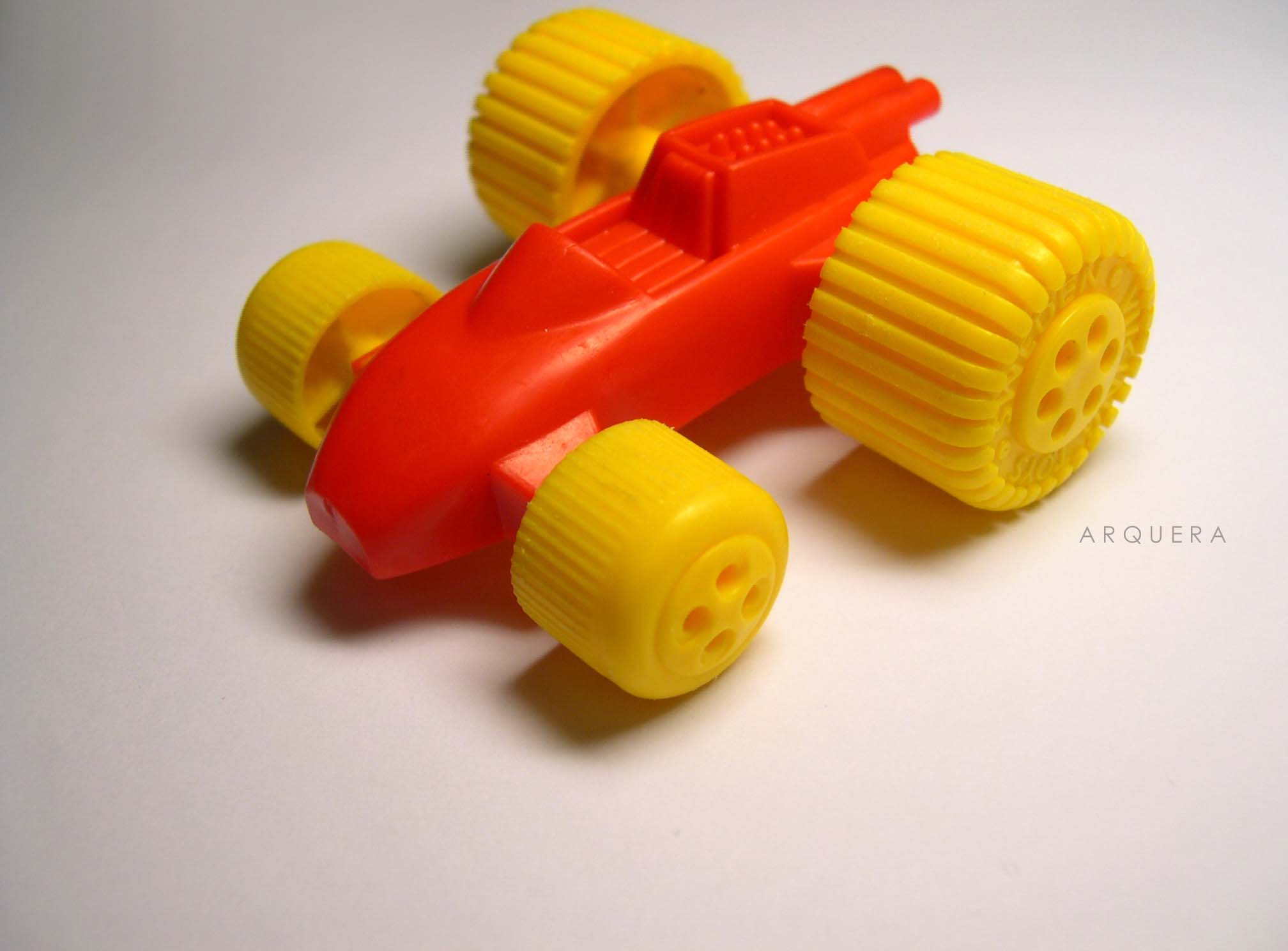 an orange toy car with a yellow body