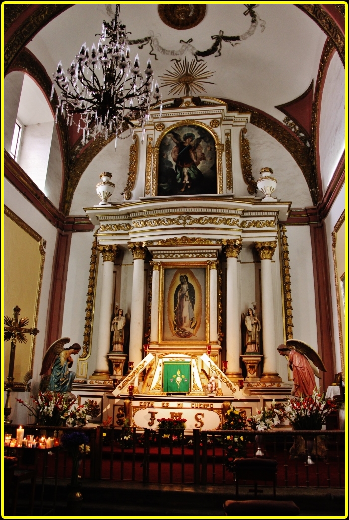 an ornate church alter with golden and red accents