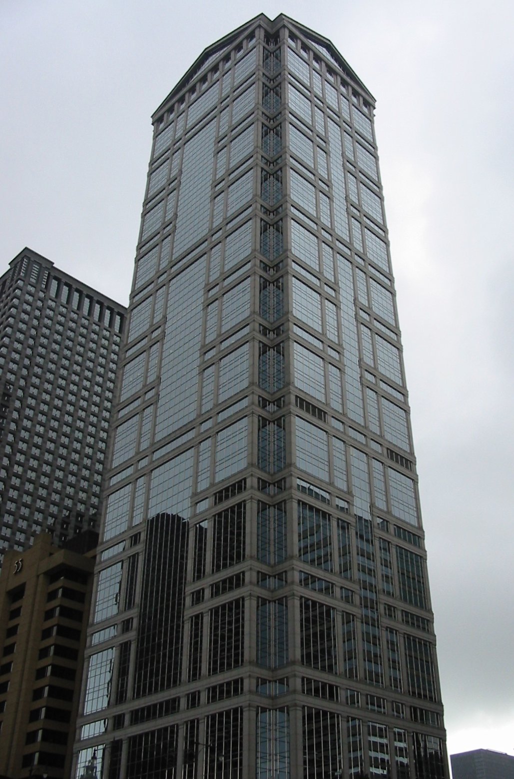 a large tall glass building with many windows on the side