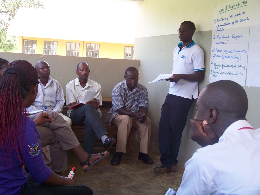 five people in a classroom talking