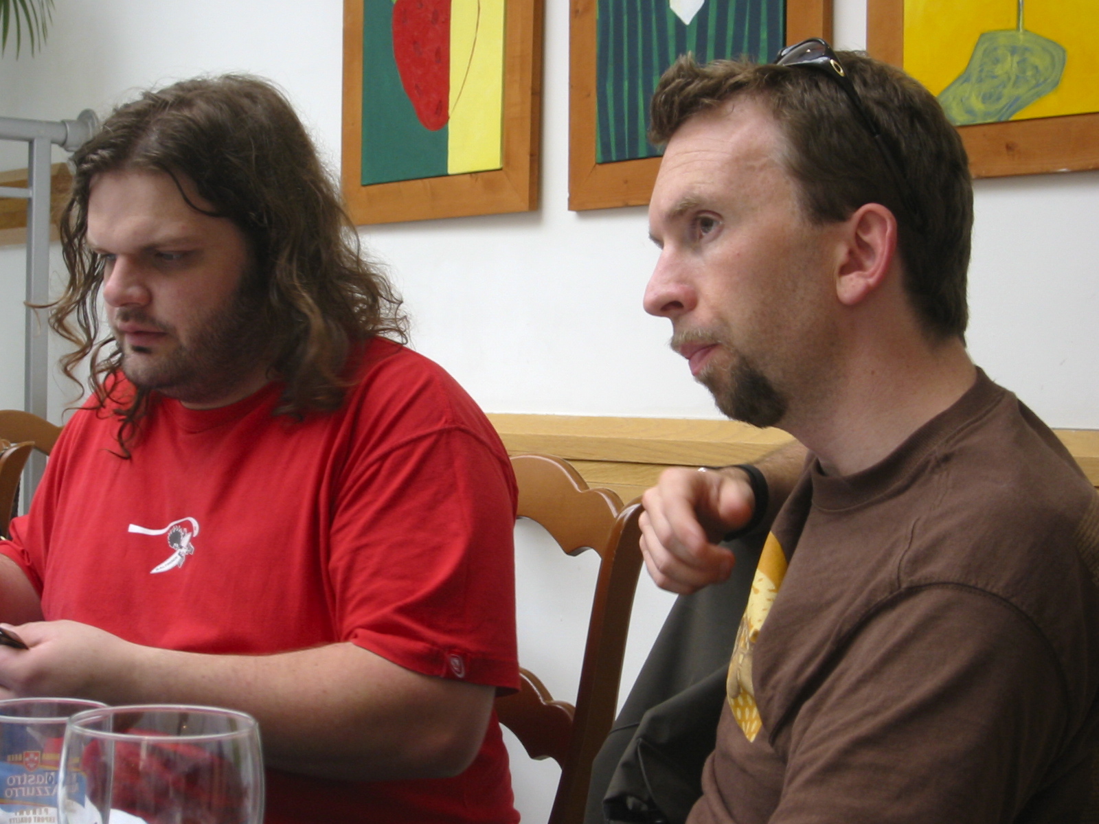 two men at a table with wine glasses