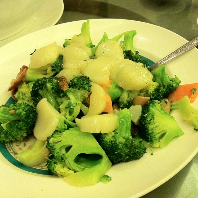 some broccoli and dumplings sitting on a plate