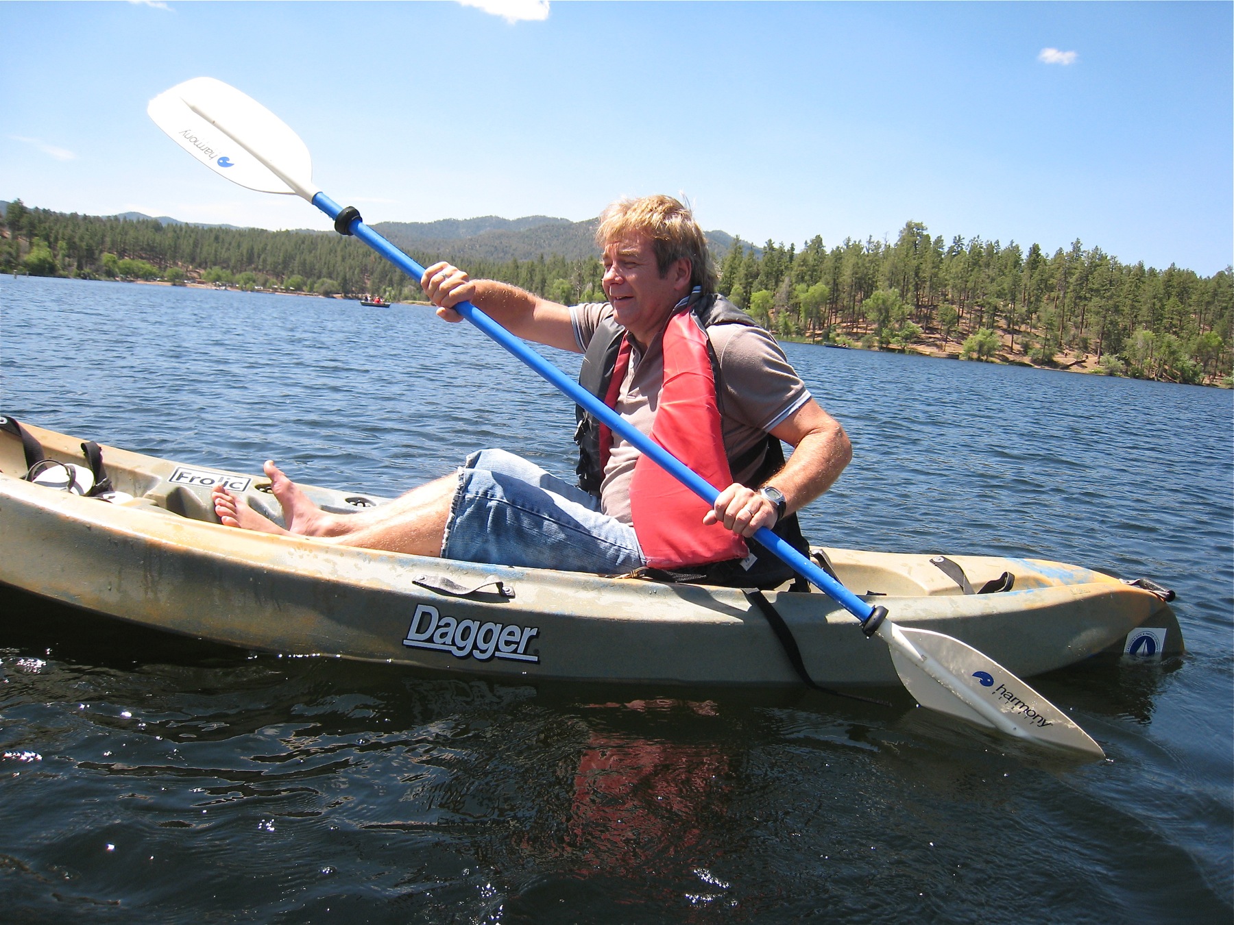 a man is in a boat on a lake