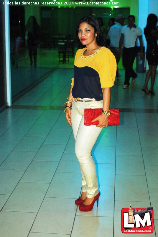a woman in jeans and high heels poses for a picture
