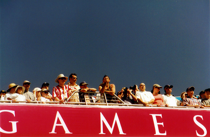 a crowd of people are sitting on a large red sign