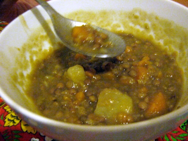 a close up of a bowl of food with spoon in it