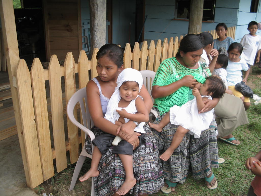 people sitting on a white plastic chair outside