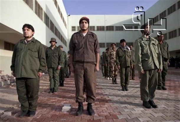 people in uniform are walking down a street