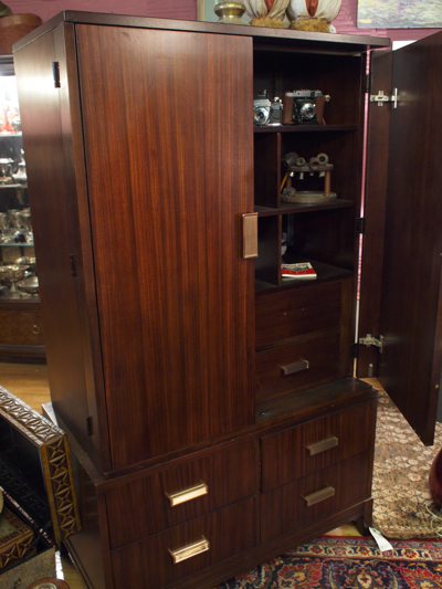 a very pretty wooden cabinet with its doors open