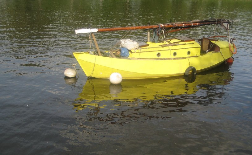 a yellow boat is out on a lake