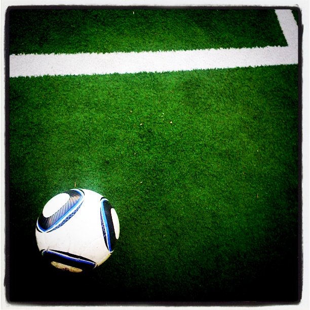 a soccer ball on the ground on a green field
