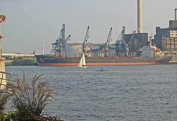 the large body of water is next to industrial buildings