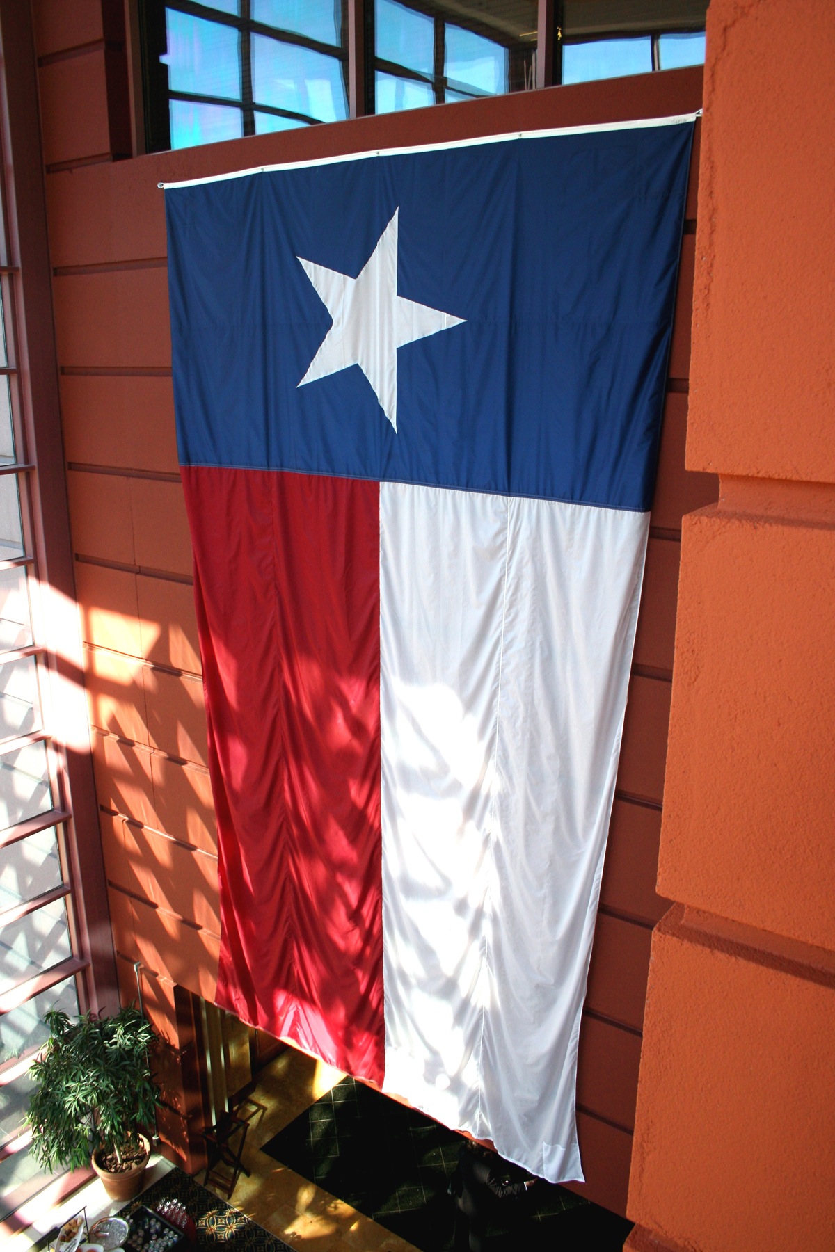 an american flag is hanging on the side of the building