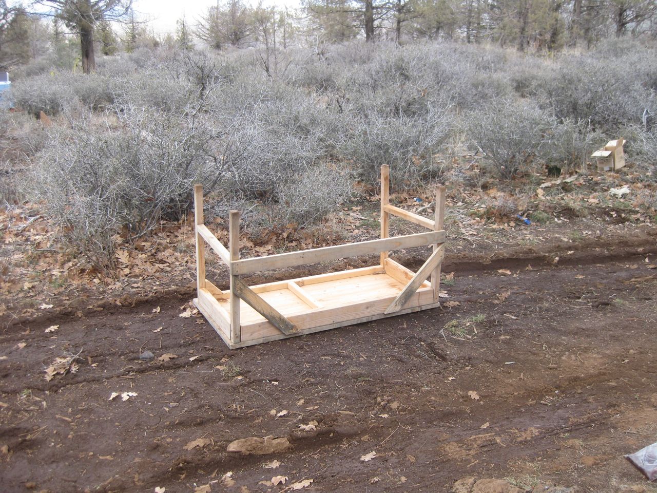 an outdoor bed made from wood with metal frame