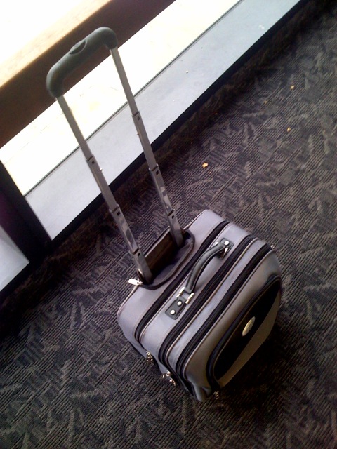 a suitcase is sitting on the floor of an airport