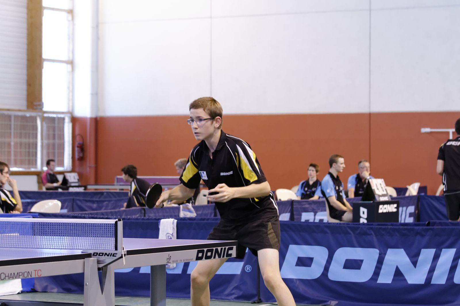 a man holding a racquet on top of a tennis court