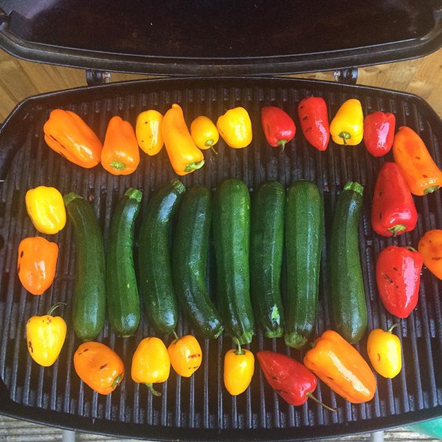 a grill full of assorted vegetables and peppers