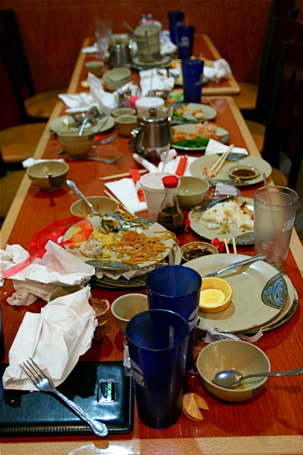 the long dining table is covered in many dishes