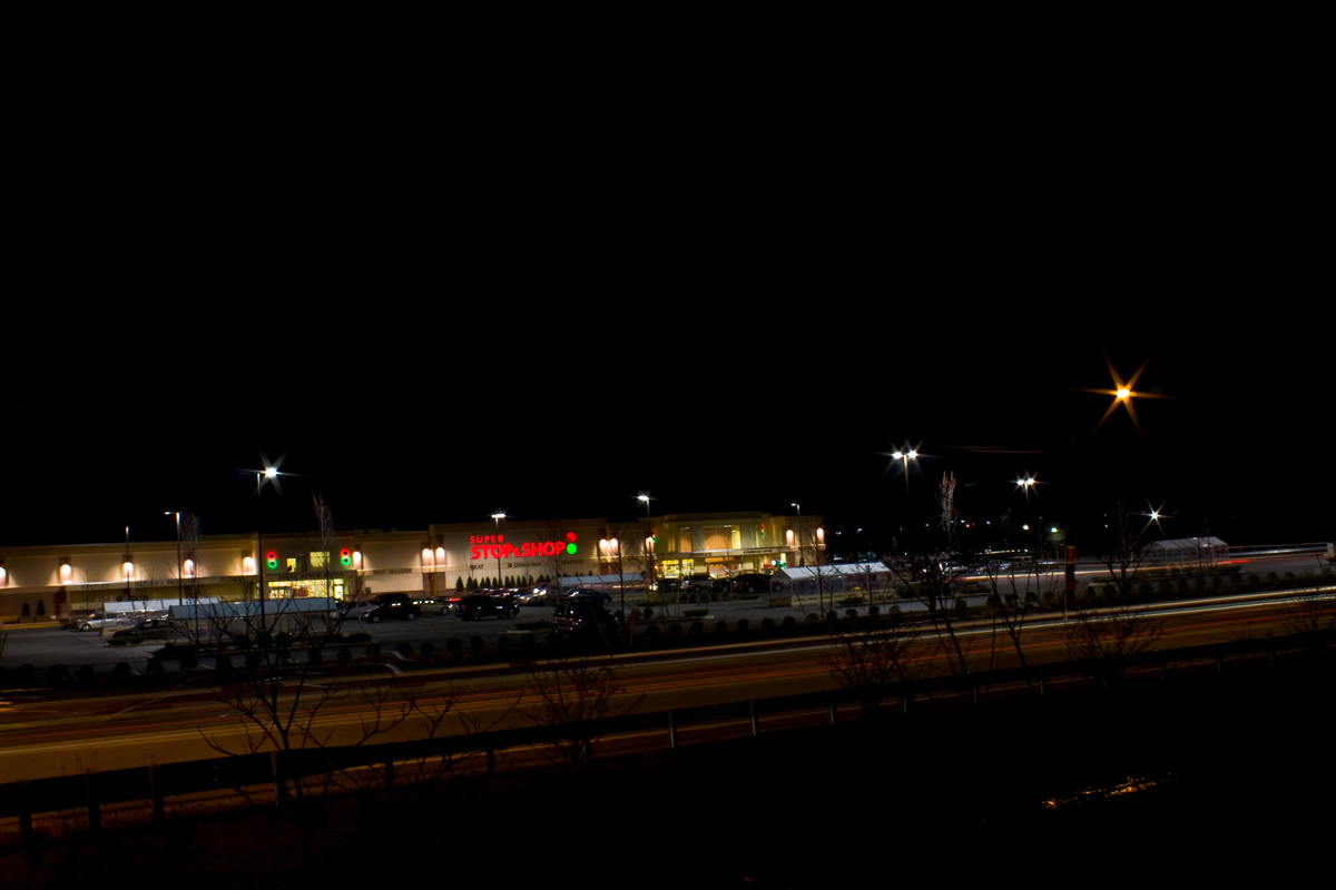 a group of trucks parked at night by a building