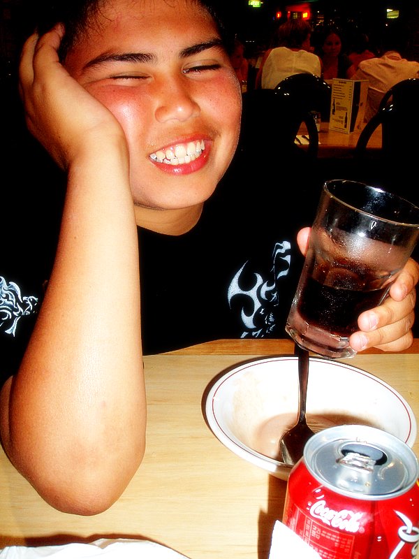 a child at a table with a glass of water