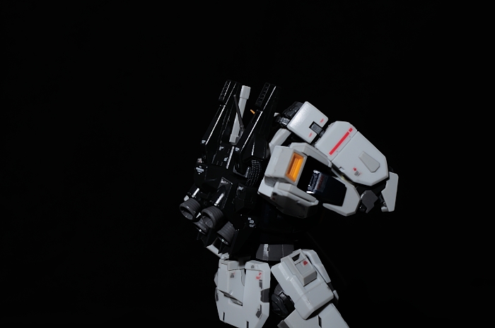 a white robot with gray legs and black eyes