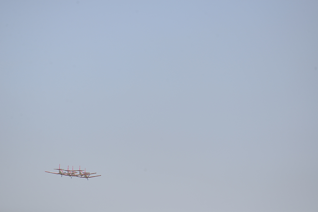 the airplane has four propellers and is flying through the sky