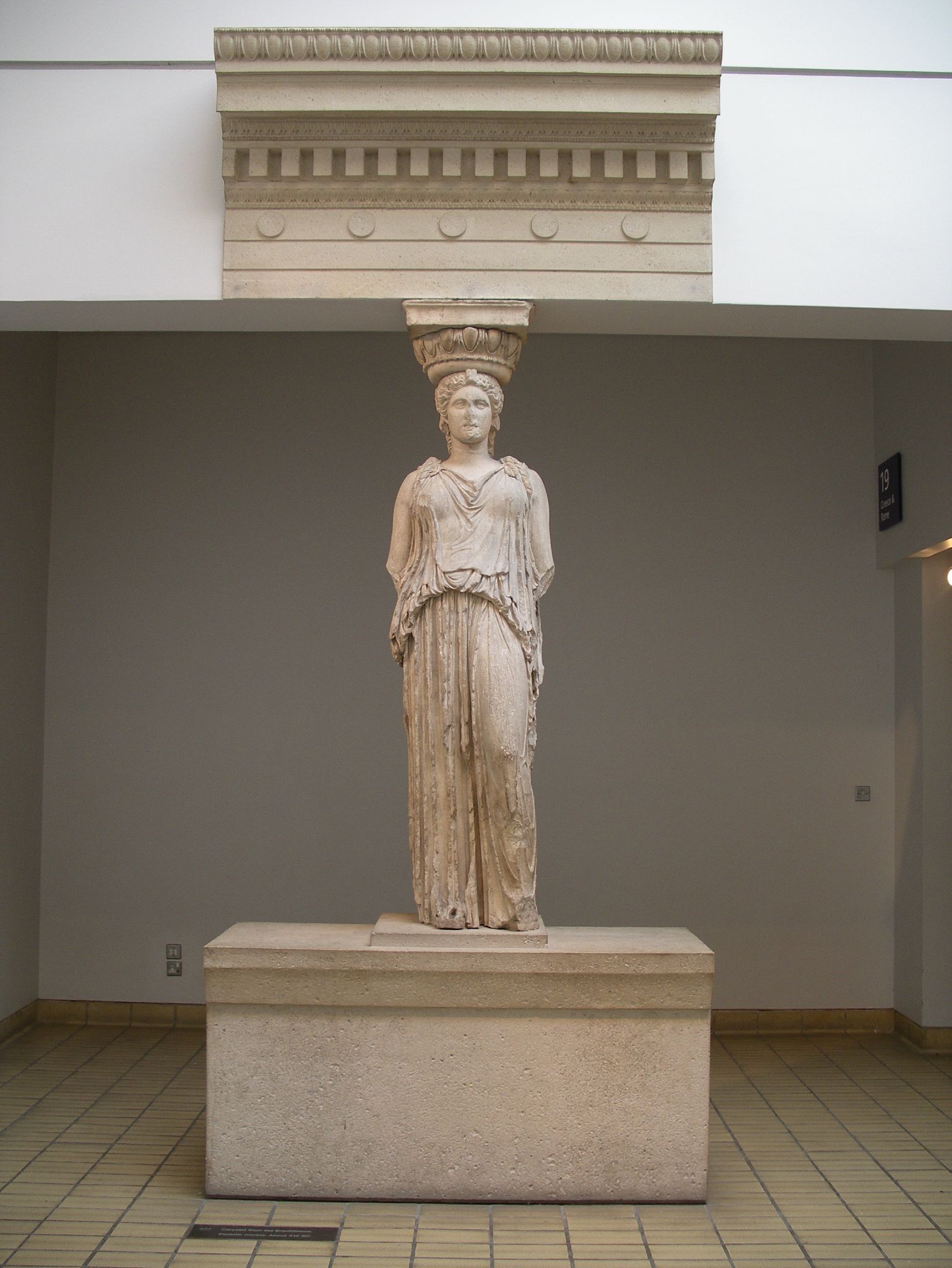 statue of an egyptian woman in a museum setting