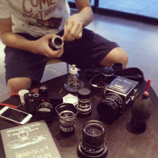 someone taking a pograph of their camera collection
