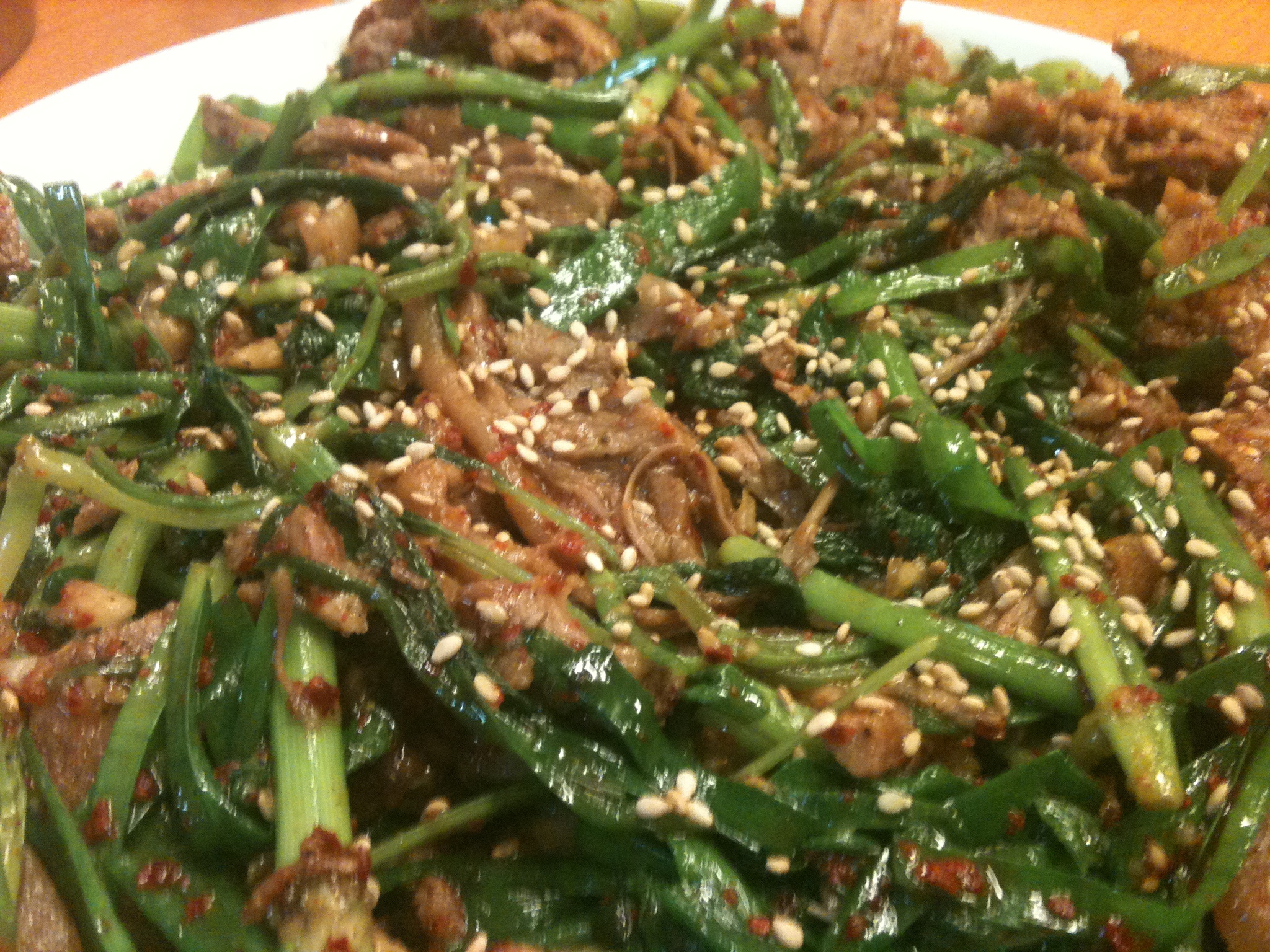 some food on a plate with sesame seeds