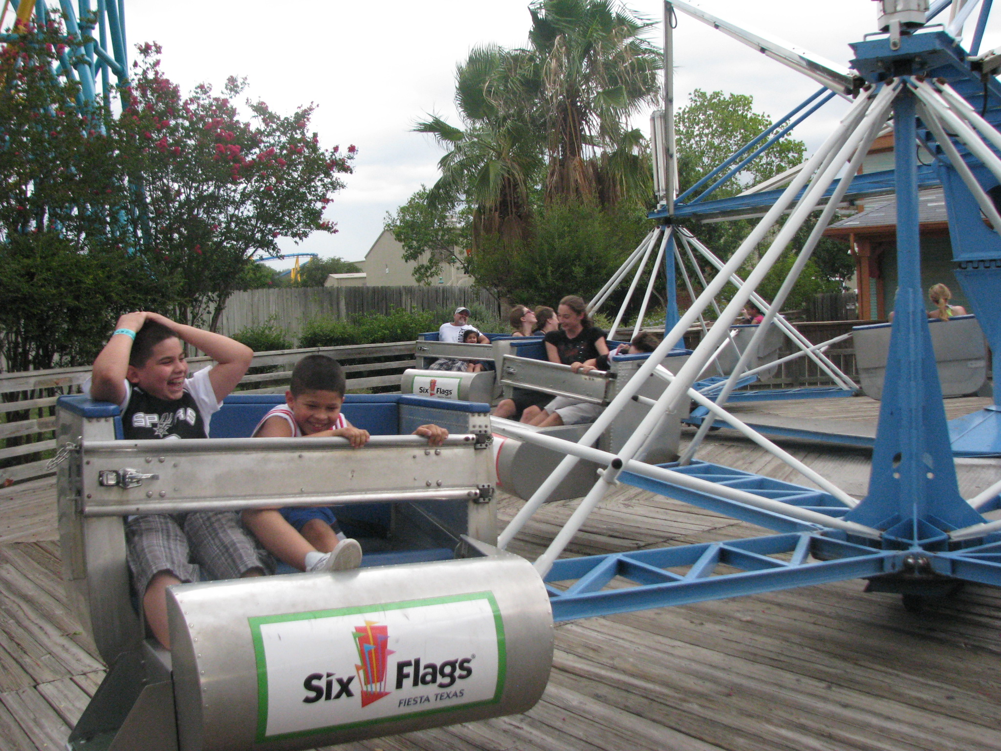 two s riding on a roller coaster in a park