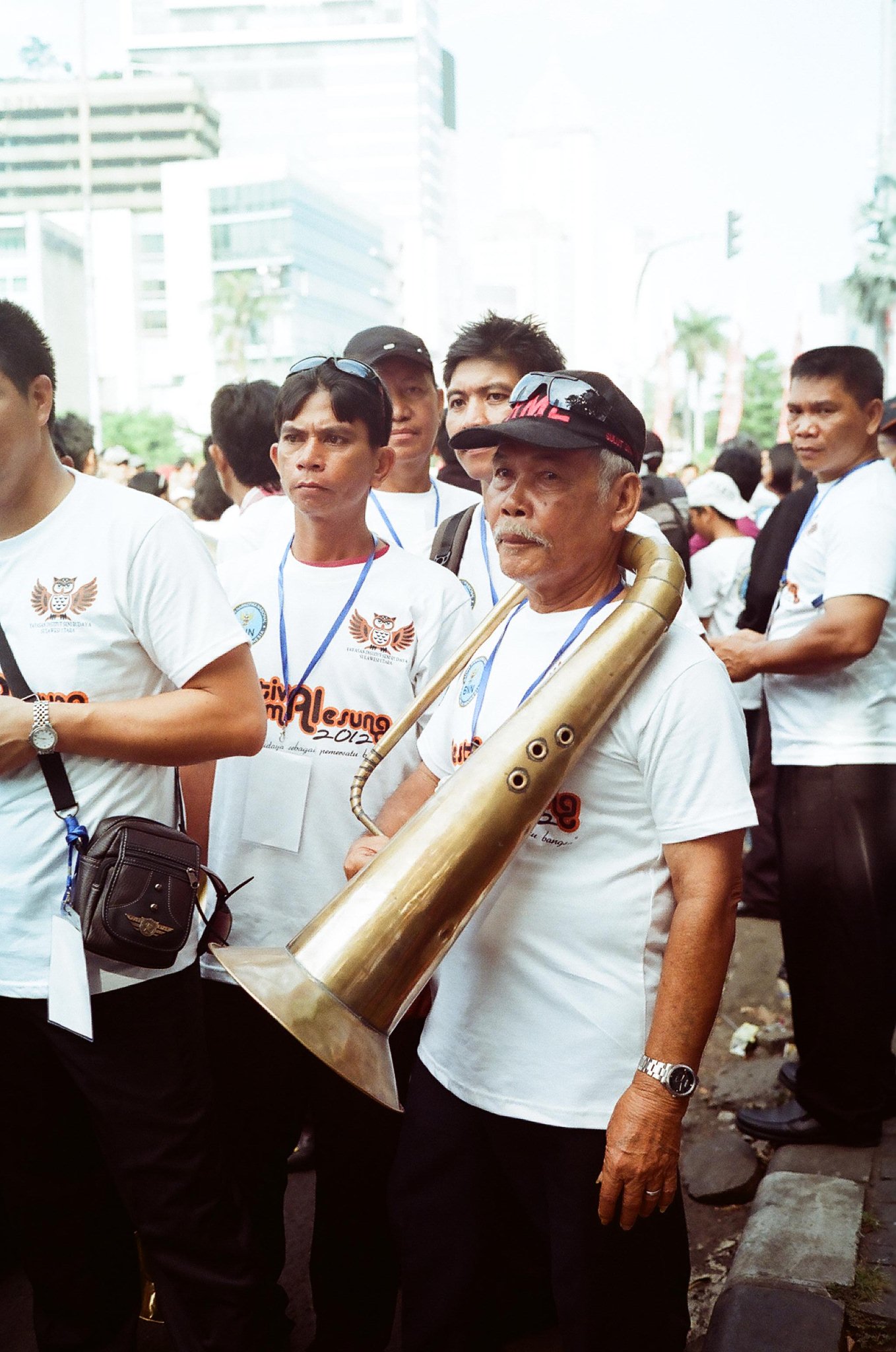 a group of people stand together holding a trumpet