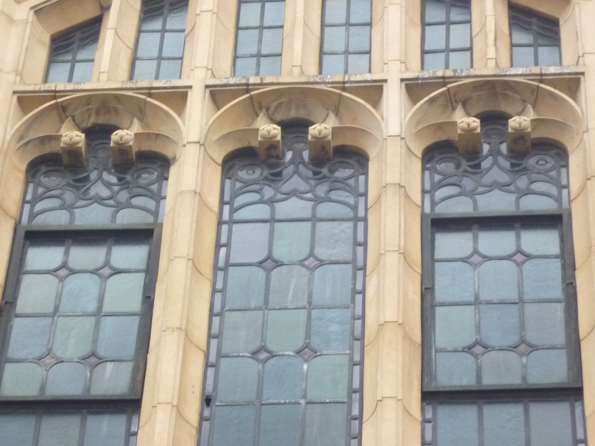 large windows with decorative art nouveau styles set into the front of a building