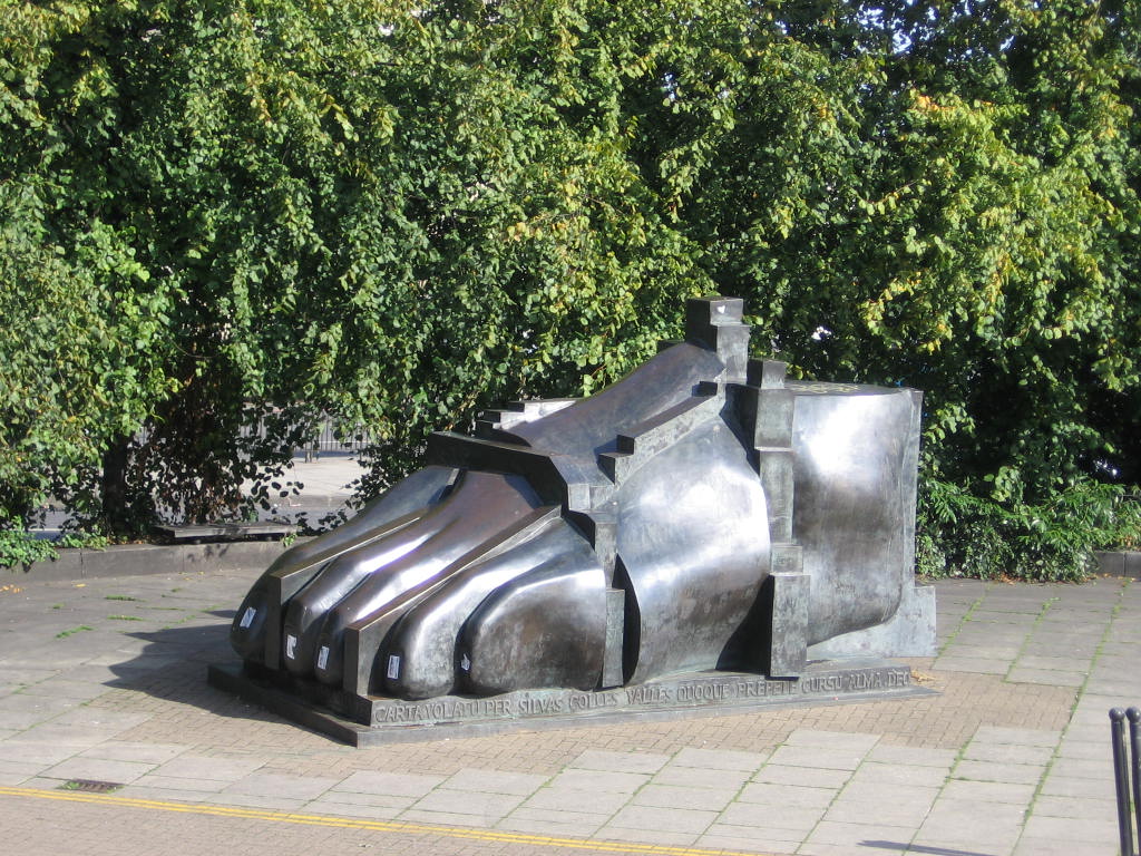 a silver object in front of a bunch of trees