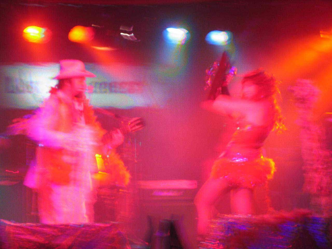 two women in fancy clothing on stage performing in a show