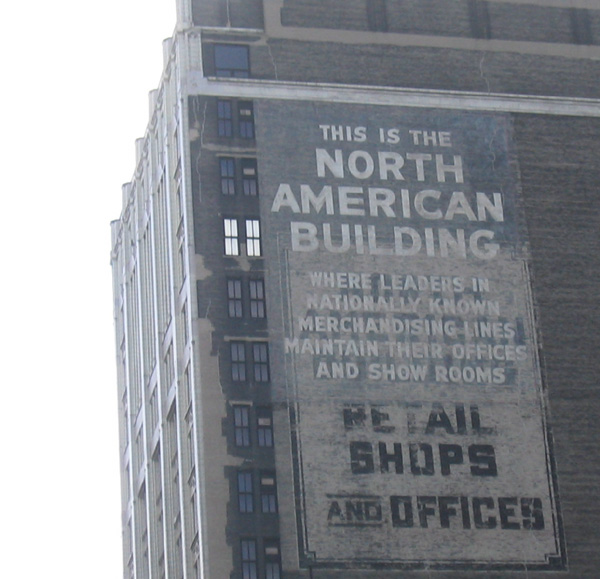 the large sign shows the building and has ads