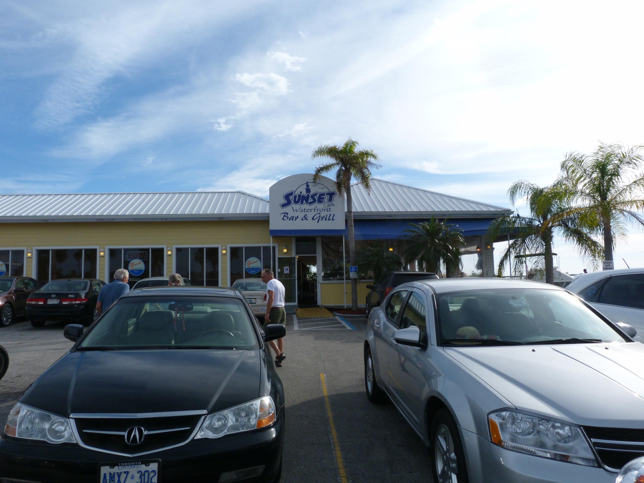 a group of cars sitting in front of a yellow building