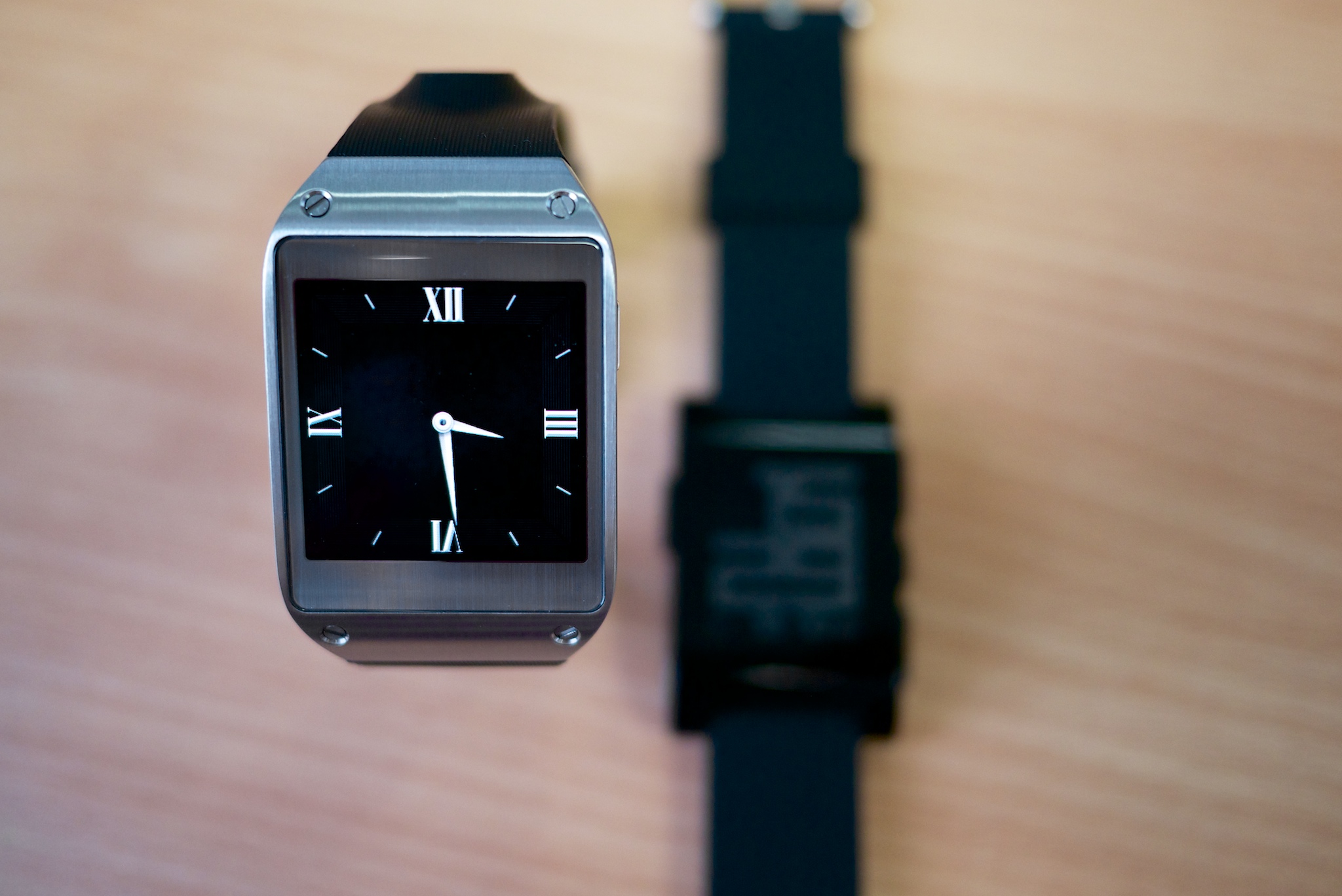 a silver smart watch with a black leather band