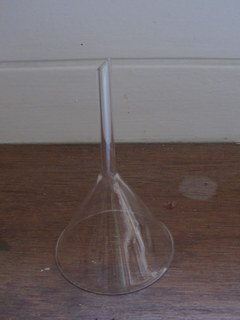 a small clear glass is sitting on the floor