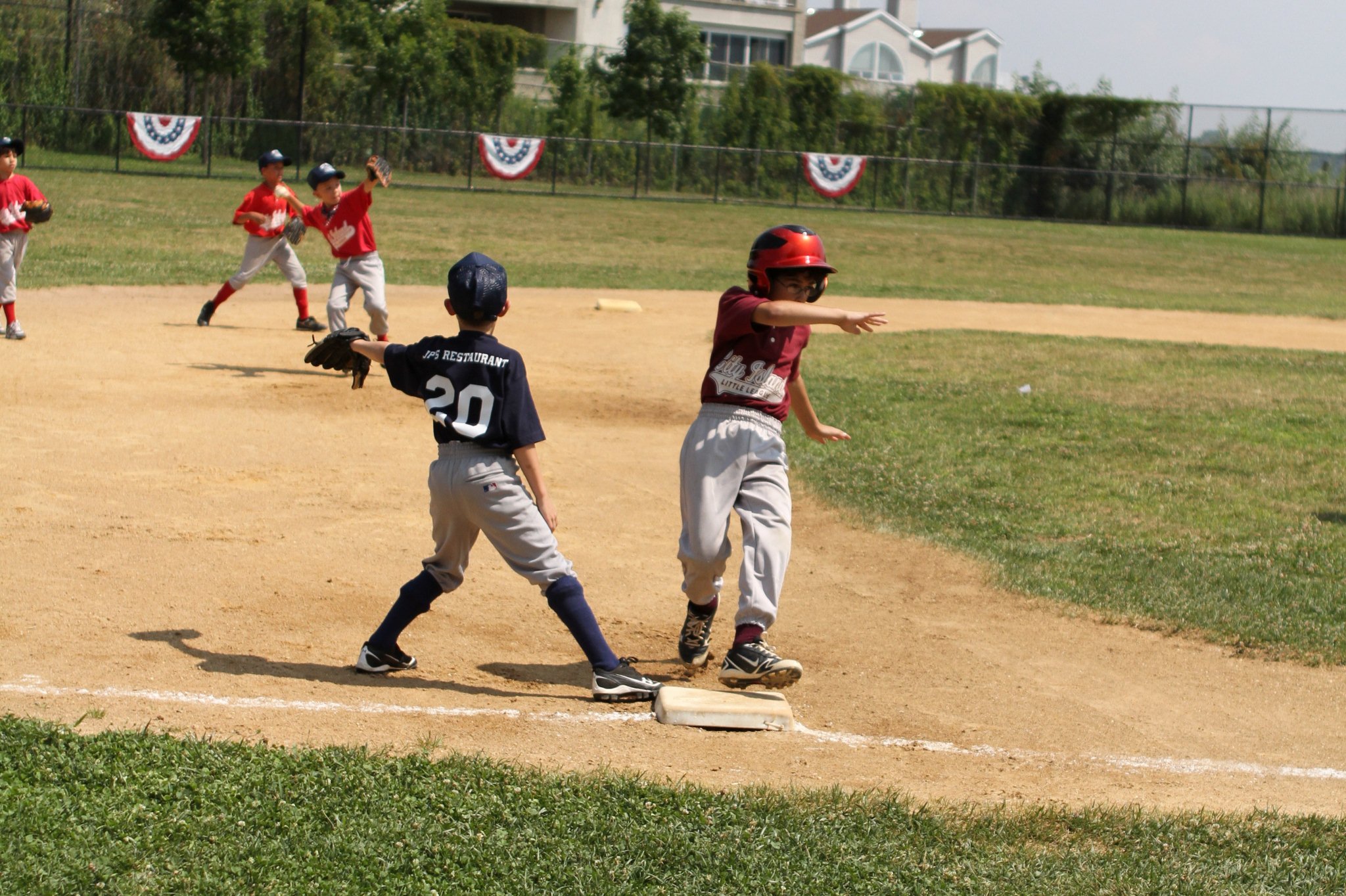 some young baseball players playing baseball on a field