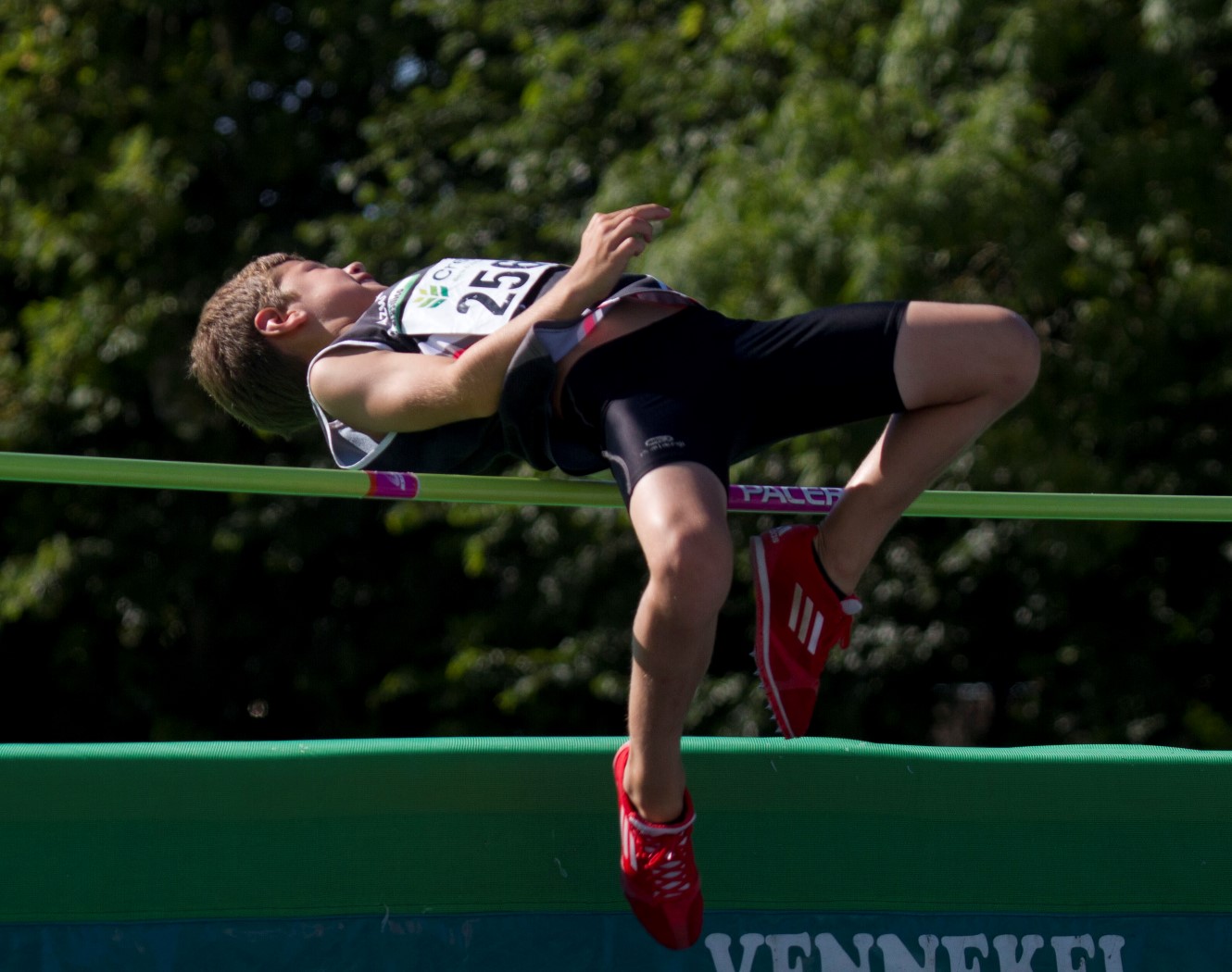 a man is jumping over an obstacle on a long rope