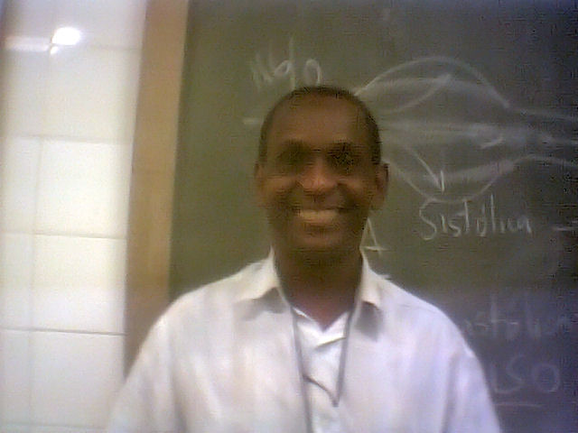 a man standing in front of a blackboard with writings