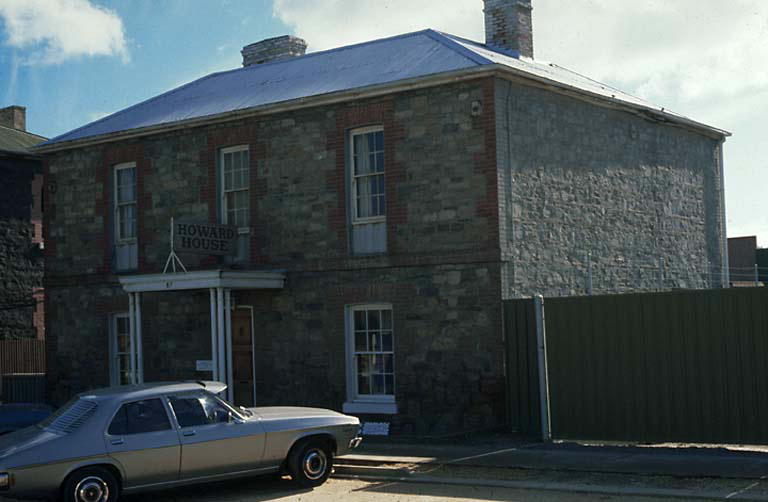 an old stone building with a small car parked in front of it