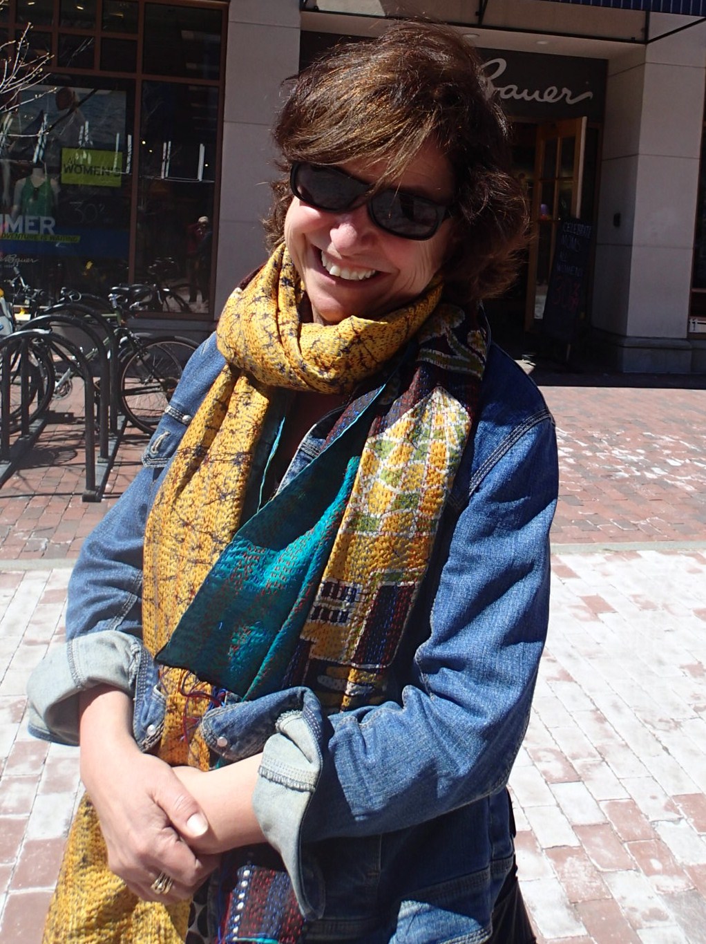 a woman in a blue jacket and yellow scarf