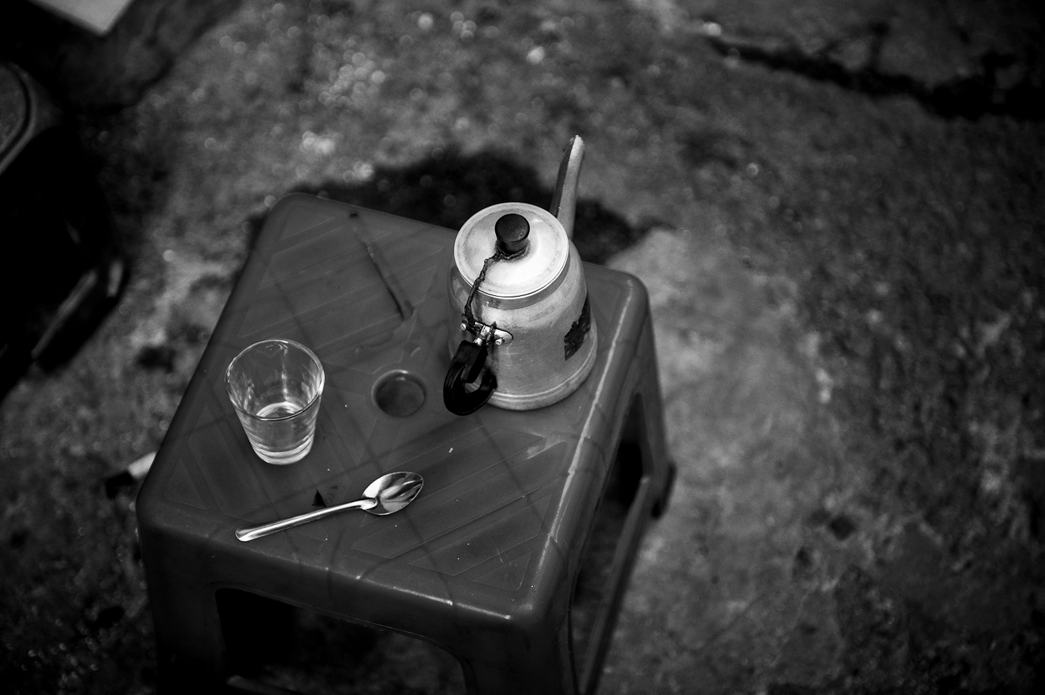 a small table with a jar and two cups on it